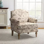 Fauteuil rembourré en bois avec motif floral, accoudoirs à panneaux et dossier en forme de bosse de chameau.
