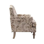 Fauteuil rembourré en bois avec motif floral, accoudoirs à panneaux et dossier en forme de bosse de chameau.